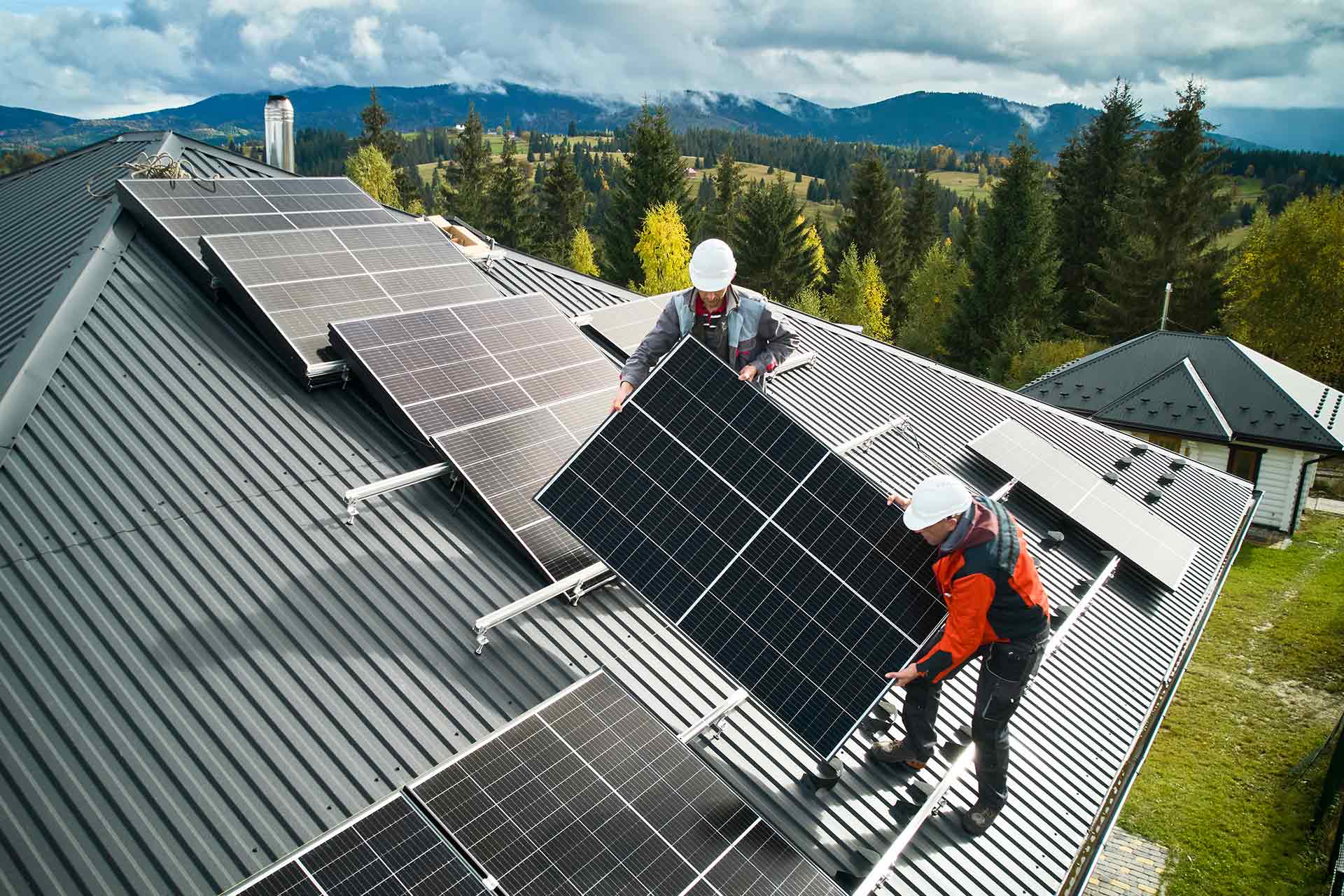 workers-installing-solar-panels-on-a-roof-of-house-2023-11-27-05-35-23-utc.jpg